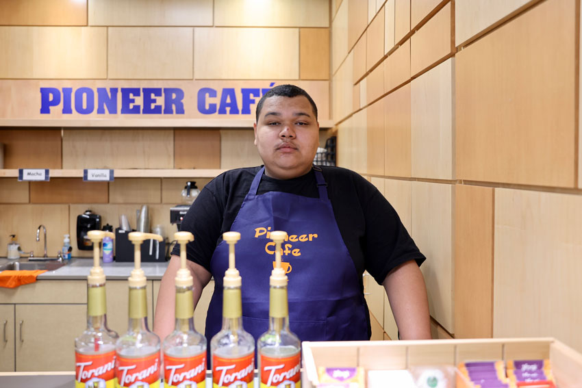 Student behind the counter of Pioneer Cafe