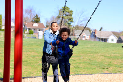 Student on swing smiling