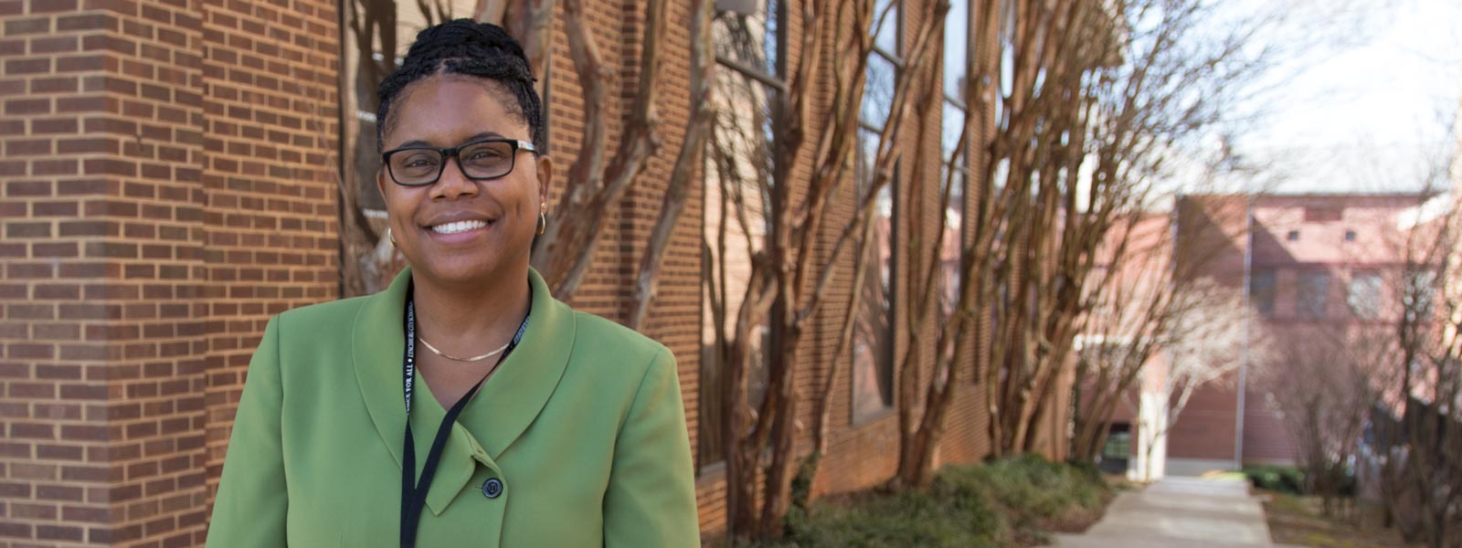 Dr. Edwards standing in front of the School Administration Building