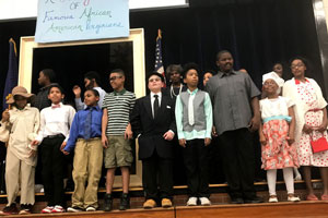 DESI students on stage dressed as famous African-American Virginians