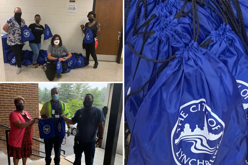 Staff in masks preparing safety kits for delivery