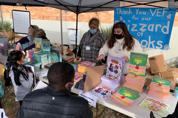 Students at table full of books