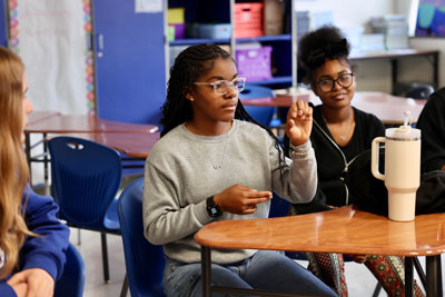 ECG student using sign language in classroom