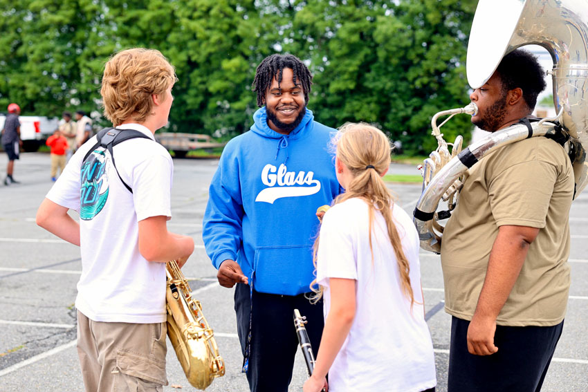 Band staff speaking with students