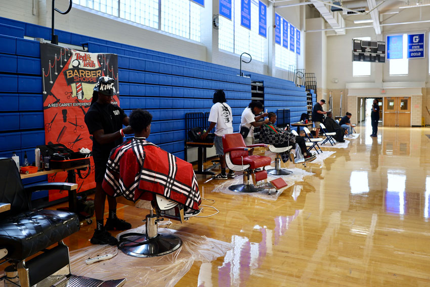 Row of barber chairs in school gym