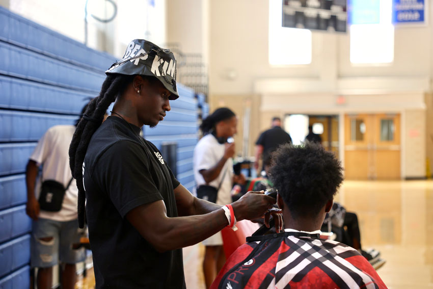 Barber cutting student's hair