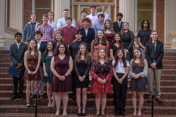 Group of senior honors recipients standing on stairs