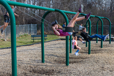 Girl on swing set wearing camera