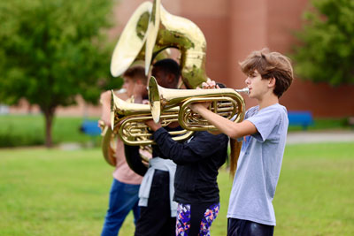 Students playing brass instruments during band practice 