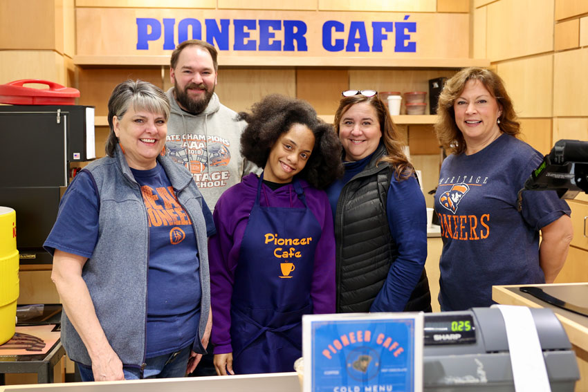 School staff with student in the Pioneer Cafe