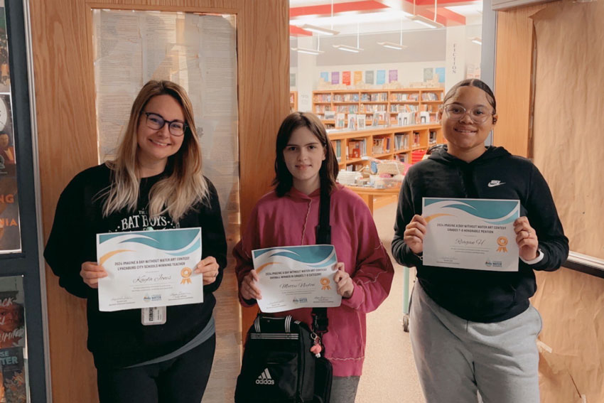 Three smiling middle school students holding certificates