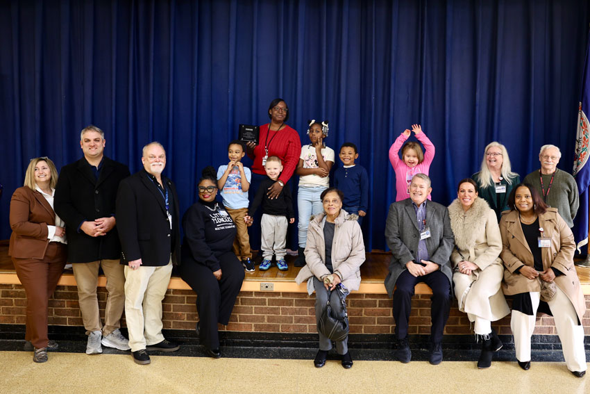 Teacher of the Year recipient on stage with students, school administrators and community leaders