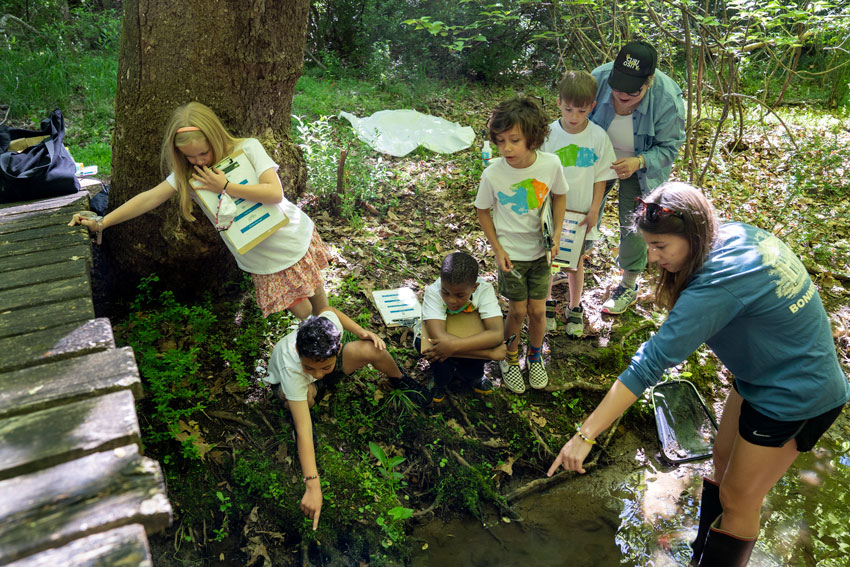 Elementary students on a field trip in the woods at Camp Kum-Ba-Yah